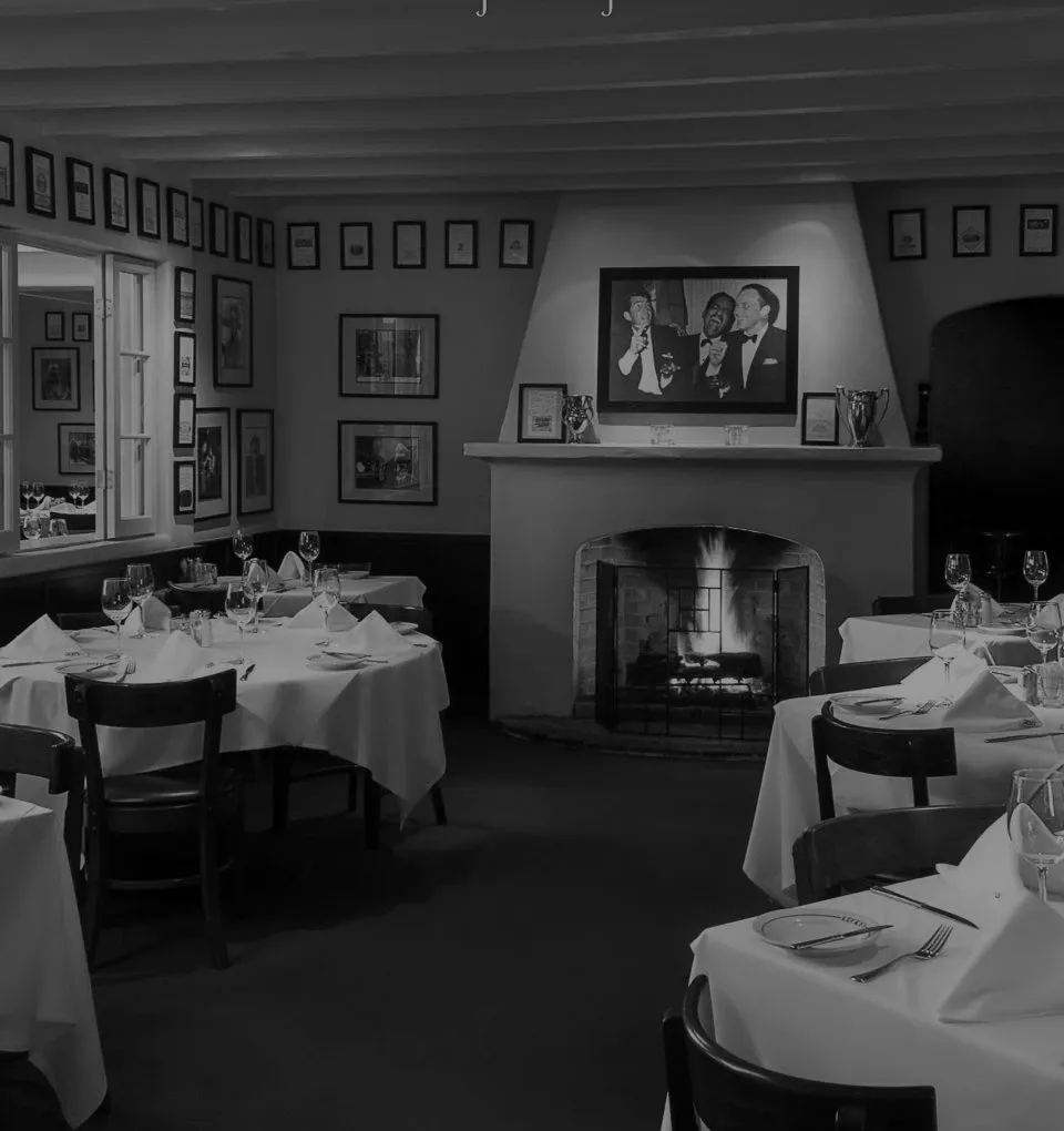 Lucky's Steakhouse Montecito interior dining room with warm lighting and classic art