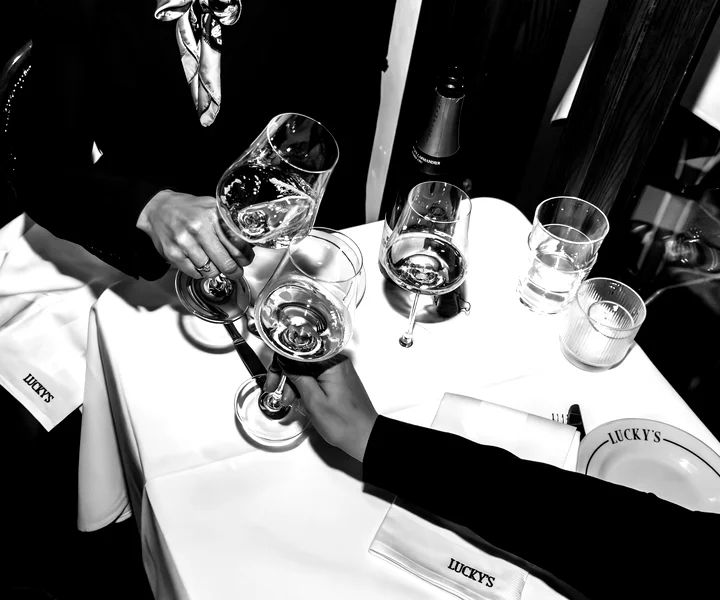 Festive group champagne toasts at Lucky's Montecito